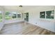 Sunroom offers an airy space with many windows and sliding door at 8402 Roxboro Dr, Hudson, FL 34667