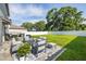 Beautifully landscaped backyard features an outdoor seating area and lush green grass at 10270 Shady Preserve Dr, Riverview, FL 33578