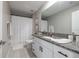 Bright bathroom features a granite countertop, a large mirror, and white fixtures at 10270 Shady Preserve Dr, Riverview, FL 33578
