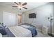 Bright bedroom features a TV, neutral walls, and ample closet space at 10270 Shady Preserve Dr, Riverview, FL 33578