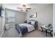 Cozy bedroom featuring a ceiling fan, a comfortable queen bed, and stylish decor at 10270 Shady Preserve Dr, Riverview, FL 33578