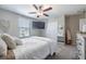Comfortable bedroom with neutral tones, ample natural light, and a decorative mirror at 10270 Shady Preserve Dr, Riverview, FL 33578