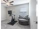Versatile bedroom featuring a spin bike and cushioned chair, offering flexibility and comfort at 10270 Shady Preserve Dr, Riverview, FL 33578