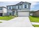 Inviting two-story home with a neatly paved driveway leading to a spacious two-car garage at 10270 Shady Preserve Dr, Riverview, FL 33578