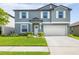 Charming two-story home featuring a well-maintained lawn, attached two-car garage, and welcoming front entrance at 10270 Shady Preserve Dr, Riverview, FL 33578