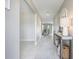 Bright hallway featuring neutral tones, decorative furnishings, and tiled flooring for a clean aesthetic at 10270 Shady Preserve Dr, Riverview, FL 33578