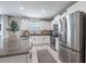 Well-lit kitchen featuring white cabinets, stainless steel appliances, and granite countertops at 10270 Shady Preserve Dr, Riverview, FL 33578
