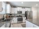 Stylish kitchen featuring white cabinets, stainless appliances and granite countertops at 10270 Shady Preserve Dr, Riverview, FL 33578