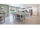 Open concept kitchen and dining area with stainless steel appliances, a dining table, and natural light at 10270 Shady Preserve Dr, Riverview, FL 33578