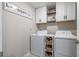 Well-organized laundry room with modern appliances, storage shelves, and a decorative sign at 10270 Shady Preserve Dr, Riverview, FL 33578