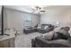 Comfortable den with gray furnishings, ceiling fan, and TV at 10270 Shady Preserve Dr, Riverview, FL 33578