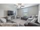Cozy den with plush gray seating and TV at 10270 Shady Preserve Dr, Riverview, FL 33578