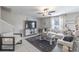 Cozy living room with neutral tones, ceiling fan, and staircase at 10270 Shady Preserve Dr, Riverview, FL 33578