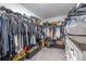 Spacious walk-in closet with custom shelving, hanging rods, and ample storage at 10270 Shady Preserve Dr, Riverview, FL 33578