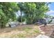 Landscaped backyard featuring mature trees, a picnic table, storage shed, and barbecue grill at 10813 Rockledge View Dr., Riverview, FL 33579