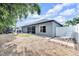 View of the rear of the house, showcasing the backyard, screened patio, and landscaping at 10813 Rockledge View Dr., Riverview, FL 33579