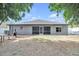 Spacious backyard with a view of the house, screened lanai, patio, and surrounding landscaping at 10813 Rockledge View Dr., Riverview, FL 33579