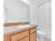 Bright bathroom featuring a clean, functional vanity and a shower-tub combination with a white curtain at 10813 Rockledge View Dr., Riverview, FL 33579