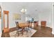 Bright dining area features hardwood floors, a modern chandelier, and beautiful natural light at 10813 Rockledge View Dr., Riverview, FL 33579