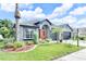 Landscaped front yard featuring lush green grass, palm trees, and colorful flowerbeds enhancing curb appeal at 10813 Rockledge View Dr., Riverview, FL 33579