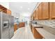 The kitchen features stainless steel appliances, tile floors, and ample counter space at 10813 Rockledge View Dr., Riverview, FL 33579