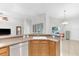 Kitchen with island, granite countertops, stainless steel dishwasher, and wood cabinetry at 10813 Rockledge View Dr., Riverview, FL 33579