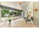 Screened lanai with brick floors, ceiling fan, seating, and views of the landscaped backyard at 10813 Rockledge View Dr., Riverview, FL 33579