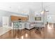 Open concept living room with wood floors, a kitchen bar, and comfortable seating at 10813 Rockledge View Dr., Riverview, FL 33579