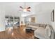 Spacious living room featuring sliding glass doors to the lanai, wood floors, and a comfortable sofa at 10813 Rockledge View Dr., Riverview, FL 33579