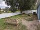 Backyard featuring a bench and hammock near the lake with a white vinyl fence at 12216 Southbridge Ter, Hudson, FL 34669