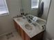 Bathroom featuring double sinks with wood cabinets, and large vanity mirror providing ample space and functionality at 12216 Southbridge Ter, Hudson, FL 34669