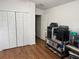 Bedroom with closet, laminate flooring, and a shelving unit with equipment at 12216 Southbridge Ter, Hudson, FL 34669