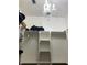 Walk-in closet with custom shelving and hanging space, illuminated by a chandelier at 12216 Southbridge Ter, Hudson, FL 34669
