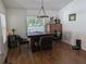 Dining area with modern chandelier, table with seating for four, and large window at 12216 Southbridge Ter, Hudson, FL 34669