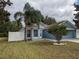 Exterior view of home with tidy front lawn and mature landscaping around bay window at 12216 Southbridge Ter, Hudson, FL 34669