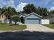 Charming single-story home with a well-manicured lawn and attached two-car garage at 12216 Southbridge Ter, Hudson, FL 34669