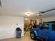 Attached garage with storage shelves and parking space for a blue Jeep at 12216 Southbridge Ter, Hudson, FL 34669