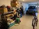 Garage features storage shelves and parking space for a blue Jeep at 12216 Southbridge Ter, Hudson, FL 34669