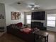 Spacious living room with vaulted ceiling, wood floors, large TV, and comfortable seating at 12216 Southbridge Ter, Hudson, FL 34669