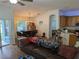 Open-concept living area with wood floors, dining table, and a view into the kitchen at 12216 Southbridge Ter, Hudson, FL 34669