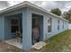 Covered patio area with outdoor seating and a grill for outdoor dining at 12216 Southbridge Ter, Hudson, FL 34669