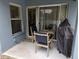Covered patio with outdoor seating, a table, and a grill under a dark cover at 12216 Southbridge Ter, Hudson, FL 34669