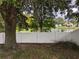 Backyard view showing a pond with trees and a distant home at 12216 Southbridge Ter, Hudson, FL 34669