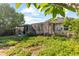 Exterior backyard featuring a partially-screened patio and tropical surroundings at 1222 Palm St, Clearwater, FL 33755