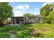 View of the backyard featuring a partially-screened in patio and lush surroundings at 1222 Palm St, Clearwater, FL 33755