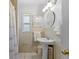 Charming bathroom features a pedestal sink, tiled walls, and decorative fixtures at 1222 Palm St, Clearwater, FL 33755