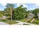 Single-story home with a well-maintained lawn, mature landscaping and a detached garage at 1222 Palm St, Clearwater, FL 33755