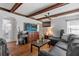 Living room featuring hardwood floors, exposed ceiling beams, and a comfortable seating area at 1222 Palm St, Clearwater, FL 33755