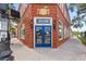 Exterior view of the brick-clad Visitor Center with a blue door and large windows, inviting tourists at 1222 Palm St, Clearwater, FL 33755