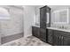 Modern bathroom featuring dual vanities, sleek finishes, and a stylish walk-in shower with tile surround at 12910 Prestwick Dr, Riverview, FL 33579